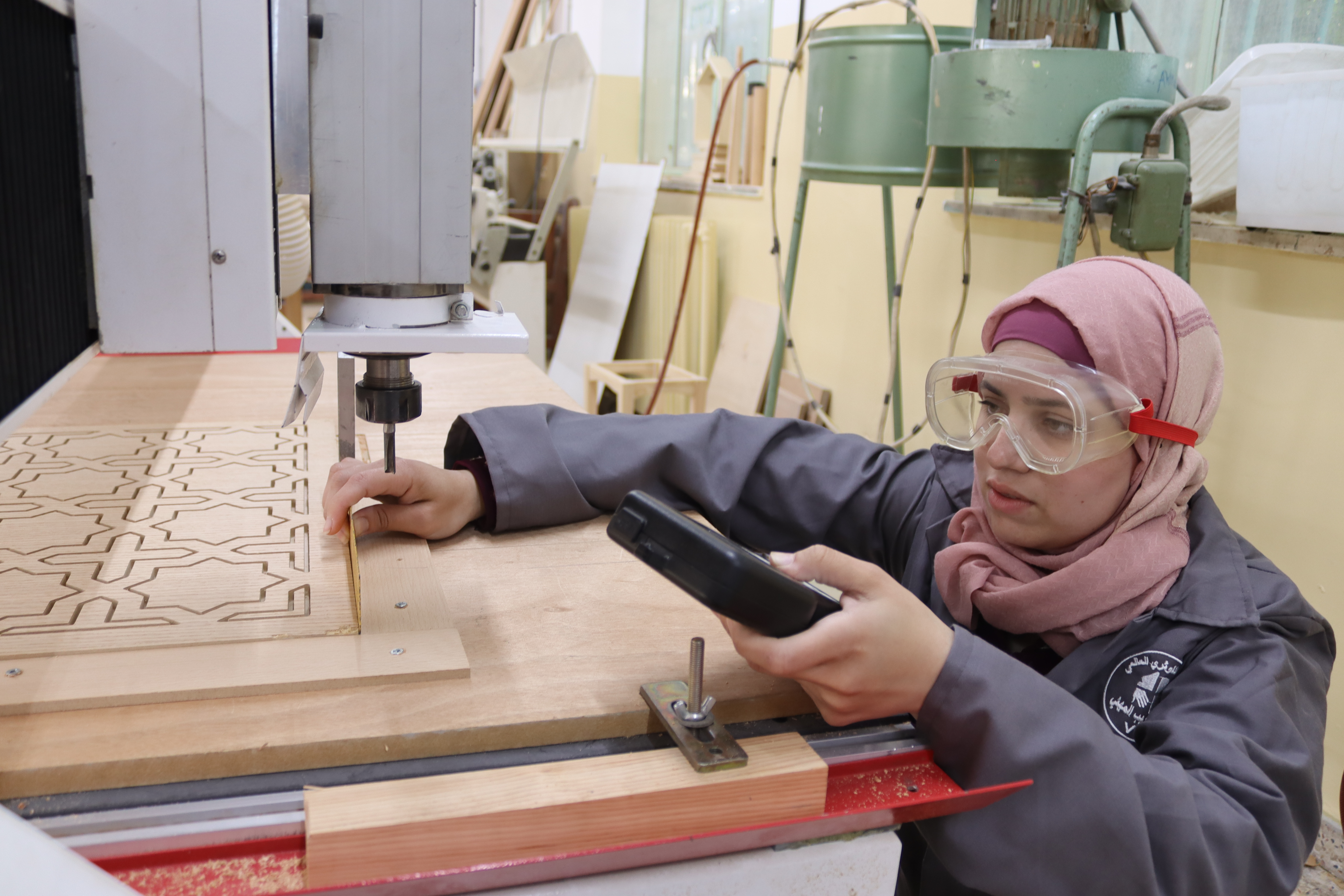 A woman conducting woodworking techniques through CLWRs GRIT program in West Bank